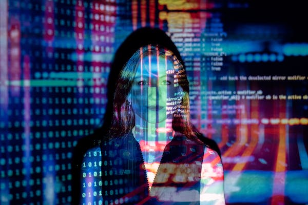 Photo of woman with colorful written code superimposed on top
