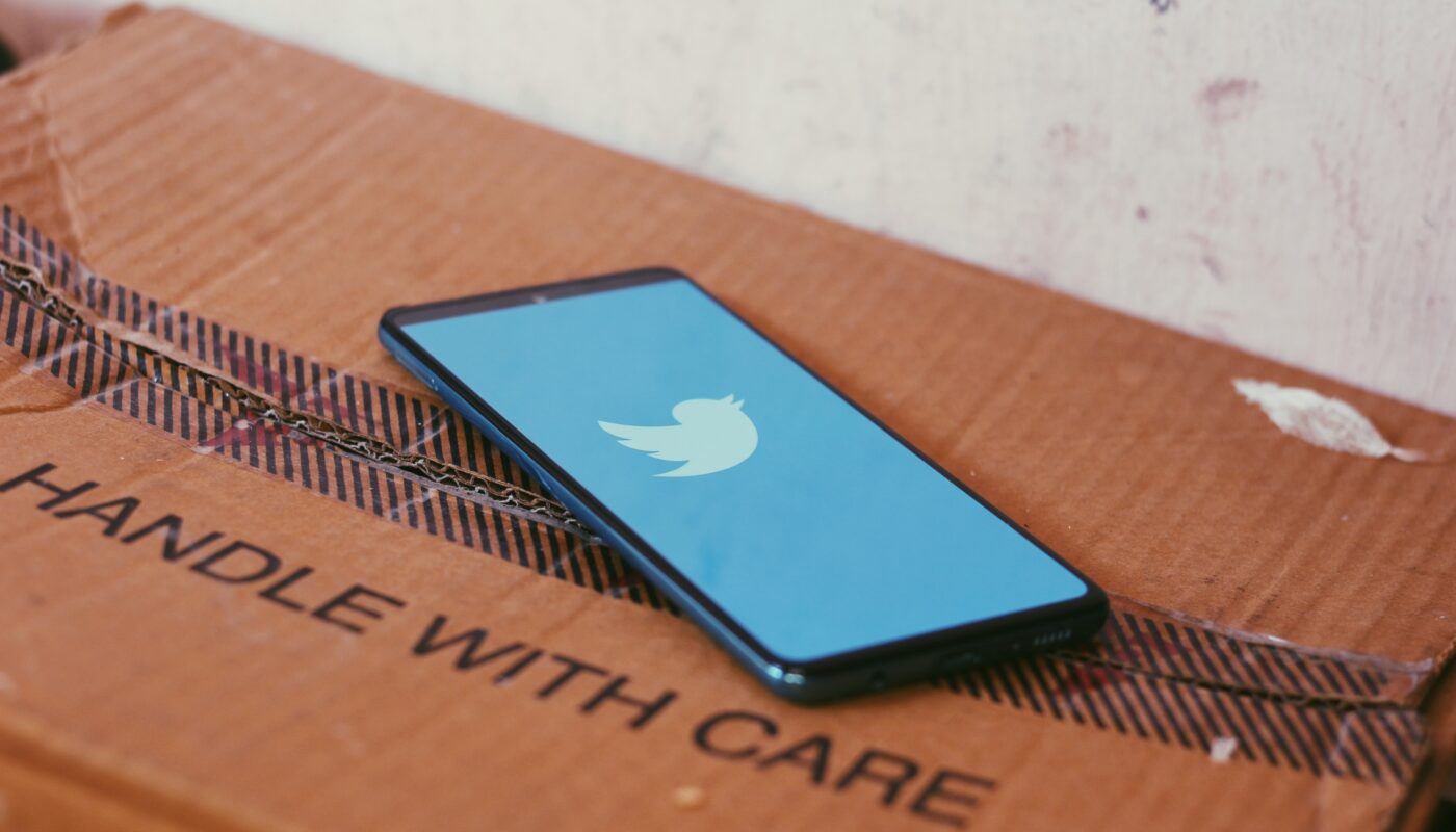Image of the Twitter app on a box that says handle with care, to demonstrate the fragility of the site